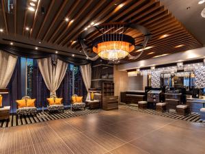 a dressing room with couches and a chandelier at APA Hotel Nagoya Fushimi Ekikita in Nagoya