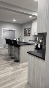 a kitchen with black counter tops and black chairs at 3 Bedroom Single Family Home in Edmonton