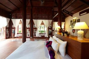 a bedroom with a large white bed with white pillows at Ho Tram Beach Boutique Resort & Spa in Ho Tram
