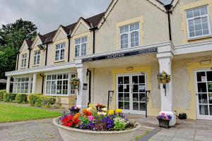 a house with flowers in front of it at The Gables Hotel, Birmingham Airport in Bickenhill