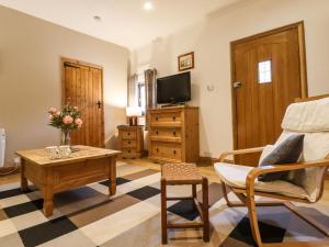 a living room with a coffee table and a tv at The Old Dairy in Herne Bay