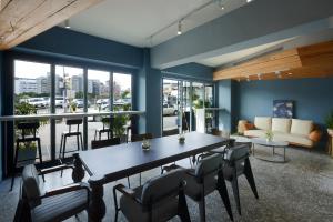 a dining room with blue walls and a table and chairs at Papersun Hotel in Taipei