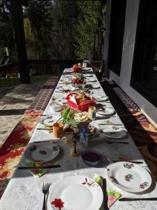 a long table with plates of food on it at Cabana Serenade in Suceviţa