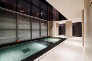 a swimming pool in the middle of a building at ibis Styles Ambassador Incheon Airport T2 in Incheon