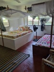 Ένα ή περισσότερα κρεβάτια σε δωμάτιο στο Mgeni Homestay