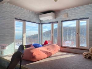 a room with a large bed in front of a window at The BASE in Otaru