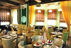 a restaurant with tables and chairs in a room at Hotel Staraya Bashnya in Sarapul