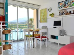 a living room with a table and chairs and a television at Appartement Argelès-sur-Mer, 2 pièces, 5 personnes - FR-1-225-579 in Argelès-sur-Mer