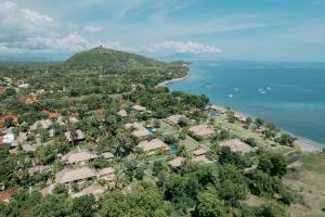 an aerial view of a village next to the water at Amertha Bali Villas in Pemuteran