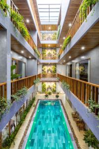 an indoor pool with plants in a building at Moon Sun Boutique Villa Hotel in Hue