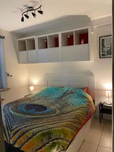 a bedroom with a large bed with white cabinets at Appartement 90m2 op 70m van het strand. in Ostend