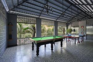 a room with a pool table and two tables at Olive Resort & Villas in Khawāsa