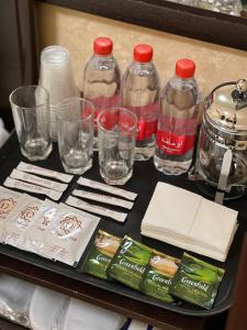 a tray with bottles and glasses on a table at Hayot Hostel in Tashkent