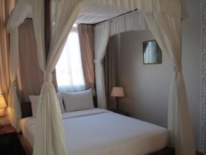 Postel nebo postele na pokoji v ubytování Anh Dao Mekong Hotel