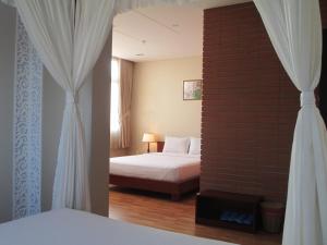 Postel nebo postele na pokoji v ubytování Anh Dao Mekong Hotel
