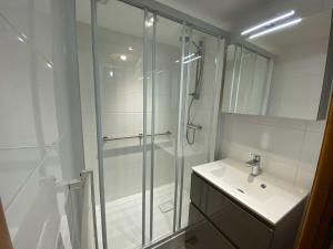 a bathroom with a glass shower and a sink at Appart. 2 pièces, 6 couchages, terrasse, garage, Le Grand-Bornand - FR-1-241-27 in Le Grand-Bornand +11 photos