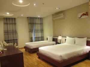 Postel nebo postele na pokoji v ubytování Anh Dao Mekong Hotel