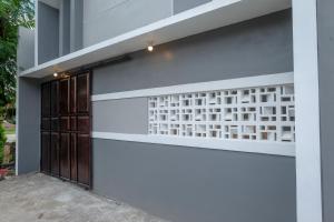 a facade of a building with a door at KoolKost near Kampus UNS Solo (Minimum Stay 6 Nights) in Solo