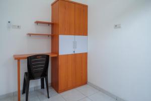 a desk and a chair in a room at KoolKost near Kampus UNS Solo (Minimum Stay 6 Nights) in Solo