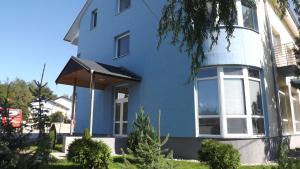a blue house with a large window at Penzión Lindava in Budmerice