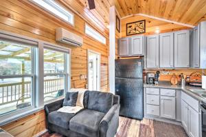 a living room with a couch and a kitchen at Newly Built Morganton Tiny Home with Deck! in Morganton