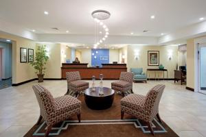 a lobby with a waiting area with chairs and a table at Holiday Inn Express and Suites Meriden, an IHG Hotel in Meriden