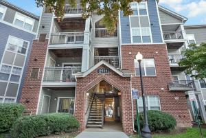 an apartment building with a staircase in front of it at Garden Styles Herndon Dulles Airport in Herndon