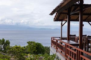 a view of the ocean from the deck of a house at D' Artha Cottage in Nusa Penida