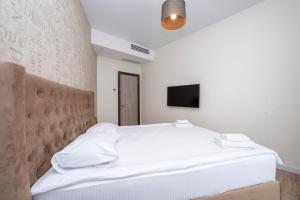 A bed or beds in a room at White Sails Residential Hotel