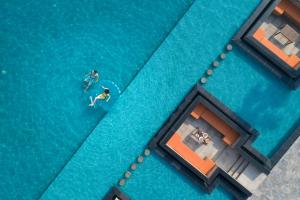 an overhead view of two people swimming in a pool at Oakwood Ha Long in Ha Long