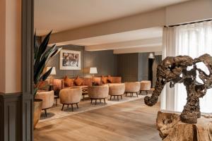 a lobby with a waiting area with chairs and a waiting room at Dukes' Academie Brugge - by Dukes' Hotel Collection in Bruges