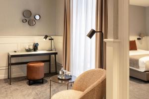 a hotel room with a bed and a table and a chair at Dukes' Academie Brugge - by Dukes' Hotel Collection in Bruges
