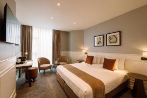 a hotel room with a bed and a desk at Dukes' Academie Brugge - by Dukes' Hotel Collection in Bruges