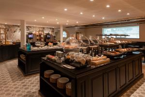 a buffet line with many different types of food at Dukes' Academie Brugge - by Dukes' Hotel Collection in Bruges