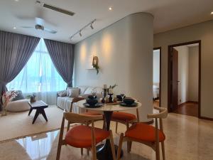 a living room with a table and a couch at Sky Suites KLCC by Asiapex in Kuala Lumpur