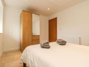 a bedroom with a bed with two towels on it at An Gwel in Penzance
