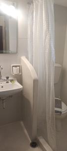 a bathroom with a shower curtain and a sink at Villa Toula in Fira