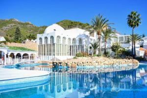 a building with a pool of water in front of it at Casa Limón in Nerja