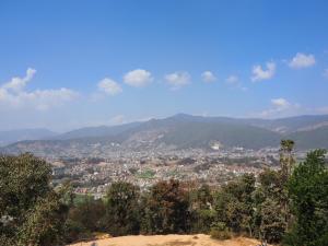 a view of a city with mountains in the background at The Nest Guest House in Changunarayan