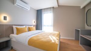 A bed or beds in a room at Vesta Rooms