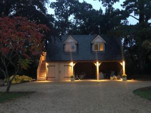 a house with a garage at night with lights at Lodge House in Grounds of Victorian Country Estate in Taunton