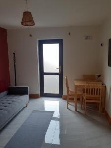 a living room with a couch and a table and chairs at AvonLodge in Waterford