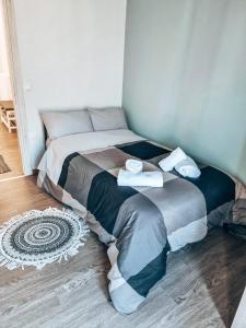 a bed with two towels on it in a room at Cozy Home in Klitoria