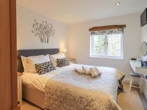 a bedroom with a bed with two pillows on it at Haystacks in Troutbeck