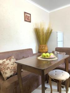 a dining room table with a bowl of apples on it at Центр (6). Поруч Став та Парк in Ternopilʼ