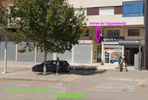 a street with a car parked in front of a store at LES CHRIFIs ETAPE AÉROPORT NAVETTE AÉROPORT GRATUITE in Fès