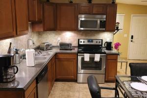 a kitchen with wooden cabinets and a stove top oven at 3 Bedroom, 2 Bath Whole House, ASU, Tempe, Scottsdale on Light Rail in Mesa