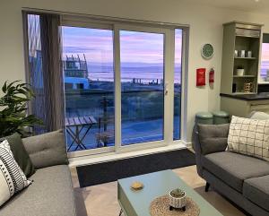 a living room with a view of the ocean at Beach View Flat on Coastal Path in Llanelli