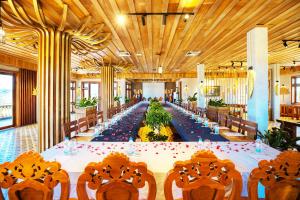a long dining room with a long table and chairs at KNN RESORT Mondulkiri in Sen Monorom