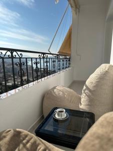 a balcony with a coffee table with a view at Comfort 2 Apartment in Sarandë